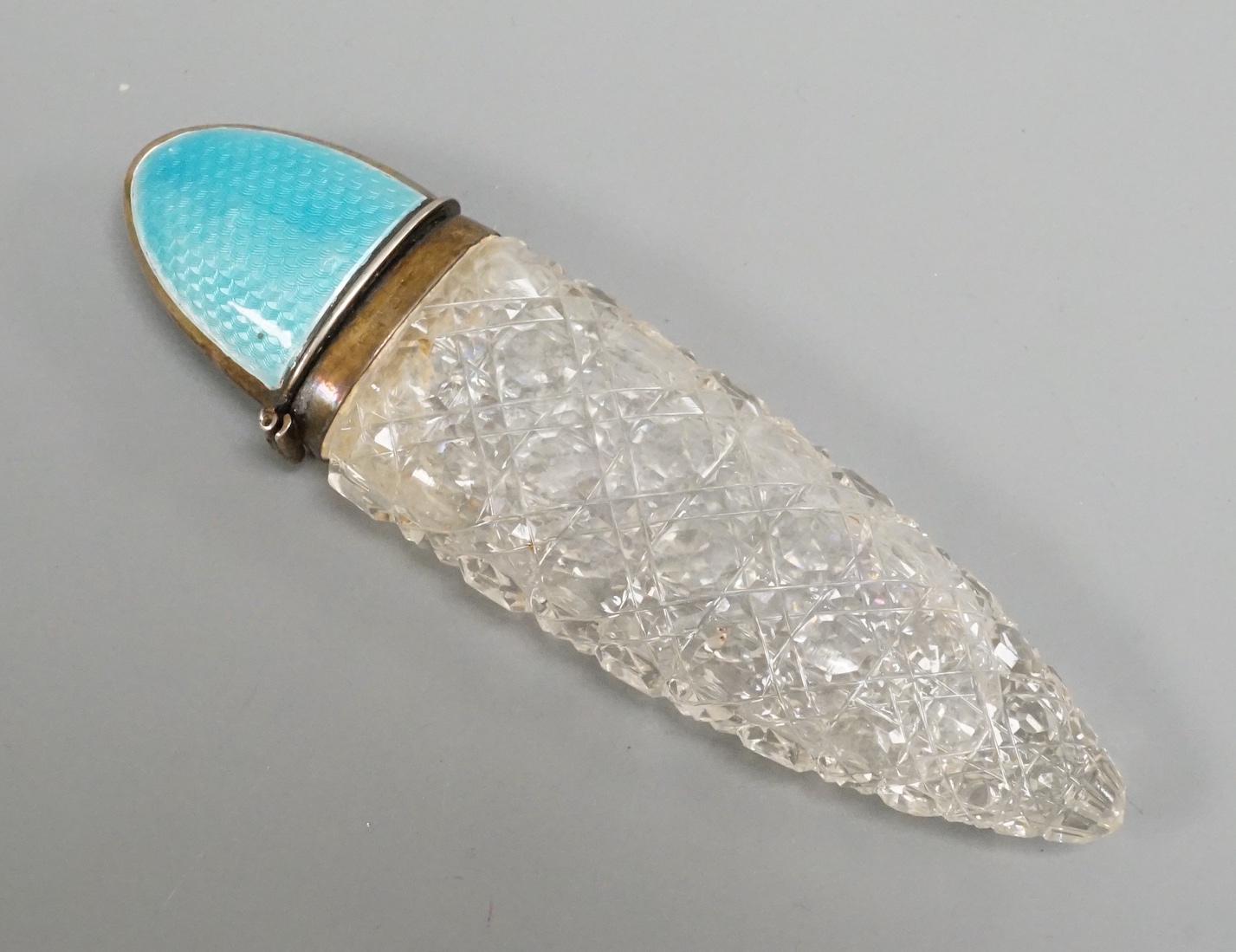 An early 20th century silver and blue enamel mounted cut glass scent bottle, Birmingham, date letter rubbed, 12cm.